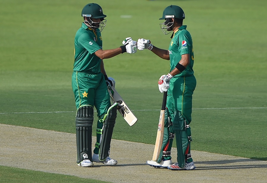 ABU DHABI, UNITED ARAB EMIRATES - OCTOBER 05: Babar Azam (R) of Pakistan celebrates scoring boundary with Azhar Ali (L) during the third One Day International match between Pakistan and West Indies at Zayed Cricket Stadium on October 5, 2016 in Abu Dhabi, United Arab Emirates. (Photo by Tom Dulat/Getty Images)